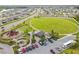 Community aerial view showcasing a large green space, playground, and parking area within a residential neighborhood at 13603 Wild Ginger St, Riverview, FL 33579