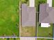 Overhead view of property with fenced backyard, next to neighboring houses and green space at 13603 Wild Ginger St, Riverview, FL 33579