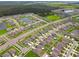 Aerial view of a new community featuring ponds and green spaces, offering a blend of nature and modern living at 13603 Wild Ginger St, Riverview, FL 33579