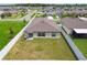 Aerial view of a private backyard featuring a green lawn, fence, and view of the neighborhood at 13603 Wild Ginger St, Riverview, FL 33579