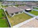 Home backyard with fence, grass, and neighboring house visible from the side at 13603 Wild Ginger St, Riverview, FL 33579