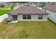Backyard with lush green grass, privacy fence, sliding glass door, and an AC unit at 13603 Wild Ginger St, Riverview, FL 33579