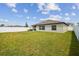 Spacious backyard with a well-kept lawn and a white fence for added privacy at 13603 Wild Ginger St, Riverview, FL 33579