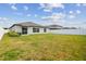Spacious backyard featuring a lush green lawn and a white privacy fence at 13603 Wild Ginger St, Riverview, FL 33579