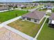 Aerial view of a fenced-in backyard featuring a well-maintained lawn and view of the neighborhood at 13603 Wild Ginger St, Riverview, FL 33579