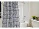 Bathroom with a toilet, tub, shower, and a zebra-striped shower curtain at 13603 Wild Ginger St, Riverview, FL 33579
