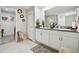 Bathroom featuring double sinks, white cabinetry, a granite countertop, and tile flooring at 13603 Wild Ginger St, Riverview, FL 33579