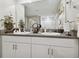 Bathroom featuring double sinks, white cabinetry, a granite countertop, and a large mirror at 13603 Wild Ginger St, Riverview, FL 33579