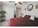 Comfortable bedroom with a ceiling fan, closet, and an ornate decorative mirror over the bed at 13603 Wild Ginger St, Riverview, FL 33579