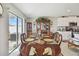 Formal dining area featuring elegant wooden furniture and sliding glass doors to the outdoor area at 13603 Wild Ginger St, Riverview, FL 33579