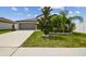 Charming single-Gathering home with a well-maintained lawn, stone accents, and a two-car garage at 13603 Wild Ginger St, Riverview, FL 33579