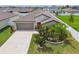 Aerial view of a well-maintained home with a stone facade and landscaped front yard at 13603 Wild Ginger St, Riverview, FL 33579