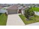 Aerial view of a beautiful home featuring a stone facade, well-manicured lawn and driveway at 13603 Wild Ginger St, Riverview, FL 33579