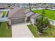 Charming single-Gathering home with stone accents, a well-kept lawn, and a two-car garage on a sunny day at 13603 Wild Ginger St, Riverview, FL 33579