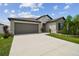 Charming single-Gathering home features a two-car garage, stone accents, and a beautifully landscaped front yard at 13603 Wild Ginger St, Riverview, FL 33579