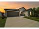 Charming single-Gathering home features a two-car garage, stone accents, and a beautifully landscaped front yard at 13603 Wild Ginger St, Riverview, FL 33579