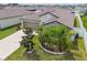 Front exterior view of a well-maintained home with stone accents, a two-car garage, and manicured landscaping at 13603 Wild Ginger St, Riverview, FL 33579