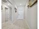 Hallway that leads to the bedrooms, featuring neutral paint and tile flooring at 13603 Wild Ginger St, Riverview, FL 33579