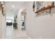 Hallway that leads to the living room and bedrooms, with neutral paint and tile flooring at 13603 Wild Ginger St, Riverview, FL 33579