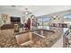 Close-up showcasing the kitchen's granite countertop and stainless steel sink, with a view of the living area at 13603 Wild Ginger St, Riverview, FL 33579