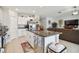 Island in the kitchen area features granite countertops, stainless steel appliances, and white cabinetry at 13603 Wild Ginger St, Riverview, FL 33579