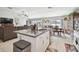 Island in kitchen, with granite countertops and views of the living room and dining area at 13603 Wild Ginger St, Riverview, FL 33579