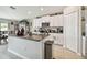 A spacious kitchen features granite countertops, white cabinetry, and stainless steel appliances at 13603 Wild Ginger St, Riverview, FL 33579