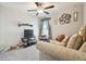 Comfortable living room with a ceiling fan, carpet, a couch, and a television at 13603 Wild Ginger St, Riverview, FL 33579
