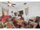Cozy living room with a comfortable sectional sofa, decorative fireplace, and ceiling fan at 13603 Wild Ginger St, Riverview, FL 33579