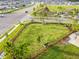 Aerial view of a fenced dog park with green space, benches, and a walking path in a residential area at 13603 Wild Ginger St, Riverview, FL 33579