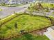 Aerial view of a green fenced in park with a bench, green space and a walking path in a residential area at 13603 Wild Ginger St, Riverview, FL 33579