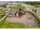 Aerial view of a colorful playground with climbing structures, swings, and slides in a community park at 13603 Wild Ginger St, Riverview, FL 33579