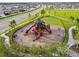 Aerial view featuring a playground with slides and climbing equipment, surrounded by green space and walkways at 13603 Wild Ginger St, Riverview, FL 33579