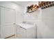 Efficient laundry room with modern washer and dryer, plus shelving for storage at 13621 Tropical Breeze Way, Hudson, FL 34669