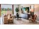 Bright living room features stylish decor, modern furniture, and a large window with a view at 13621 Tropical Breeze Way, Hudson, FL 34669