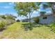 Expansive backyard featuring lush green grass and mature trees offering shade at 14204 Yacht Club Blvd, Seminole, FL 33776