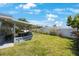 This is a backyard that has green grass and plants at 14204 Yacht Club Blvd, Seminole, FL 33776