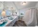 This is a bathroom with a vanity, shower with a curtain, and a blue sink at 14204 Yacht Club Blvd, Seminole, FL 33776