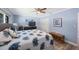 This is a large bedroom featuring a ceiling fan, and a blue-patterned bedspread at 14204 Yacht Club Blvd, Seminole, FL 33776