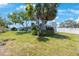 Charming single-story home featuring lush landscaping and a well-maintained lawn at 14204 Yacht Club Blvd, Seminole, FL 33776