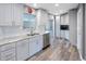 Bright kitchen featuring modern appliances, white cabinets, and granite countertops at 14204 Yacht Club Blvd, Seminole, FL 33776