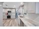Bright kitchen featuring modern appliances, white cabinets, and granite countertops at 14204 Yacht Club Blvd, Seminole, FL 33776