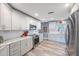 Bright kitchen featuring modern appliances, white cabinets, and granite countertops at 14204 Yacht Club Blvd, Seminole, FL 33776