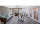 Bright sunroom featuring modern furniture, bar, and ceiling fan at 14204 Yacht Club Blvd, Seminole, FL 33776
