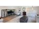 Open living area with wood flooring, entertainment center, seating and a view of connecting rooms at 14204 Yacht Club Blvd, Seminole, FL 33776