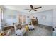 Bright sunroom featuring modern furniture, bar, and ceiling fan at 14204 Yacht Club Blvd, Seminole, FL 33776