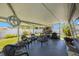An outdoor patio with chairs, a table, and BBQ at 14204 Yacht Club Blvd, Seminole, FL 33776