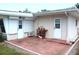 Backyard patio with red brick pavers, two doors, and exterior paint in a matching hue at 1445 Wilson Rd, Clearwater, FL 33755