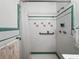 Bathroom featuring a white shower with green trim and floral accents at 1445 Wilson Rd, Clearwater, FL 33755