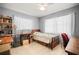 Bedroom with a light blue wall paint color, tile floors, a small desk, and two large windows at 1445 Wilson Rd, Clearwater, FL 33755
